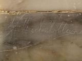 a close up of a marble statue with writing on it