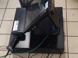 a laptop computer sitting on top of a stand on the floor