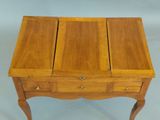 an image of a wooden table with three drawers on it