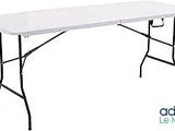 a white table with black legs and a white table top