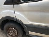 a white van that is parked on the side of the road