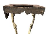 an old wooden table with a bird on it