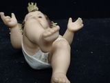 a small doll of a baby with a crown on it ' s head