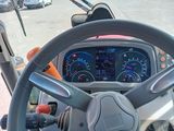 a steering wheel and dashboard of a bus