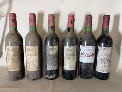 several bottles of wine are lined up in a row on a table