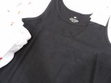 a black tank top with a white shirt underneath it