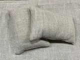 two pillows that are sitting on a couch