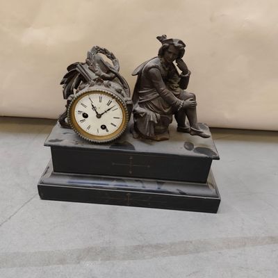a statue of a man and a woman sitting next to a clock