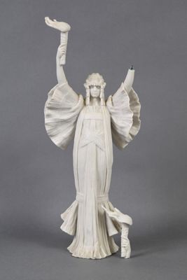 statue of a woman holding a bird in her right hand