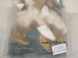 two stuffed animals in a plastic bag on a table