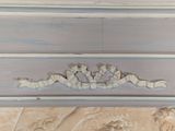 a close up of a piece of furniture with carvings on it