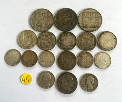 several different coins are arranged in a circle on a white surface
