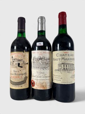 trois bouteilles de vin posées l'une à côté de l'autre sur une table