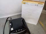 a television and a mirror on the ground next to a wall