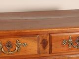 a wooden chest of drawers with brass handles on it