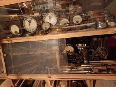 many different types of clocks on display in a glass case
