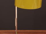 an image of a yellow lamp on a wooden table