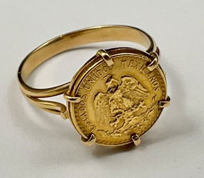 an image of a gold ring with a gold coin on it