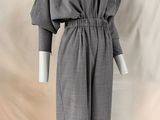a mannequin wearing a gray dress with long sleeves and a v neckline