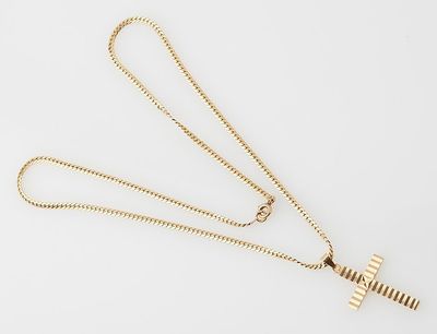 a gold necklace with a cross pendant on a chain