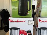 three boxes of coffee makers are on a table in a store