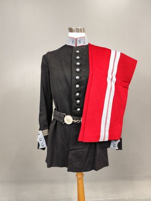 an image of a uniform on a mannequin with a red and white sash