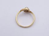 a close up of a gold ring with a diamond in the center