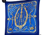 a close up of a blue cushion with a gold initial on it