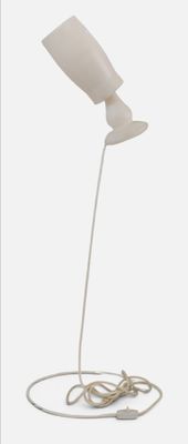a white lamp that is on a white table