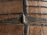 a close up of a wooden door with metal latches