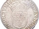 a close up of a silver coin with a crown on it