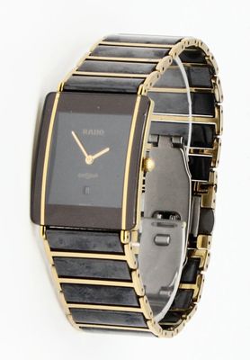 an image of a black and gold watch on a white background