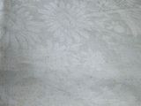 a white table cloth with a flower design on it