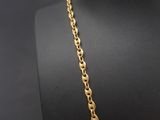 a gold chain necklace with a heart pendant on a mannequin