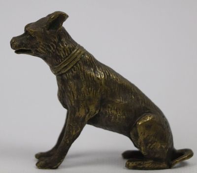 statue of a dog sitting on its hind legs with a collar around it ' s neck