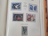 an open book with stamps on it sitting on top of a table