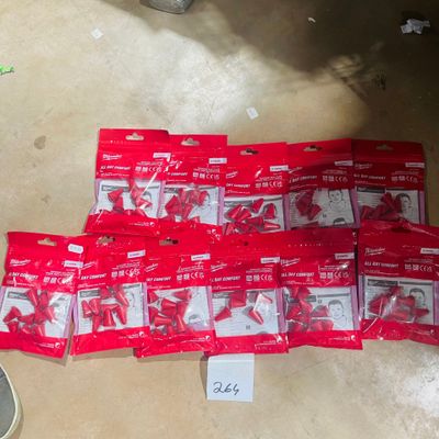 a pile of red bags of toothbrushes on the floor