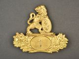gold plated clock with a lion holding a shield on top of it