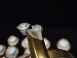 a person holding a gold plate with a banana in it