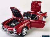 a red toy car with its hood open on a white background