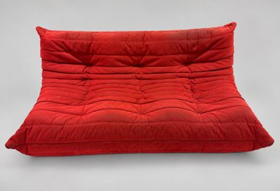 a red futon chair with a red cushion on it