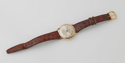 a close up of a wrist watch on a white surface