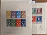 a couple of stamps sitting on top of a table next to each other