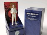 a figurine of a man in a white suit in a blue box