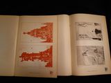 an open book with a picture of a city and a picture of a building