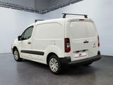 the white van is parked in the garage with its luggage on the roof