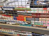 many books in a metal basket on a shelf
