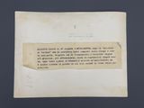 un vieux morceau de papier avec une écriture dessus, posé sur une table