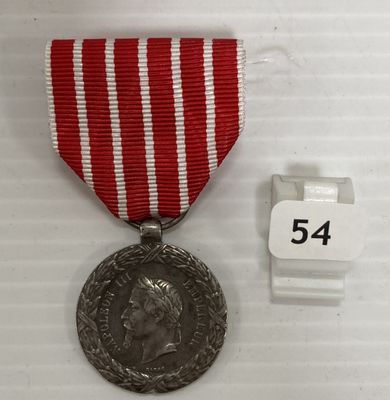 une image représentant une médaille ornée d'un ruban rouge et d'une médaille en argent