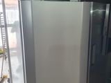 a silver refrigerator in the middle of a room